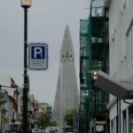 View of Hallgrimskirkja Church amidst Reykjavík's vibrant street scene, Iceland.